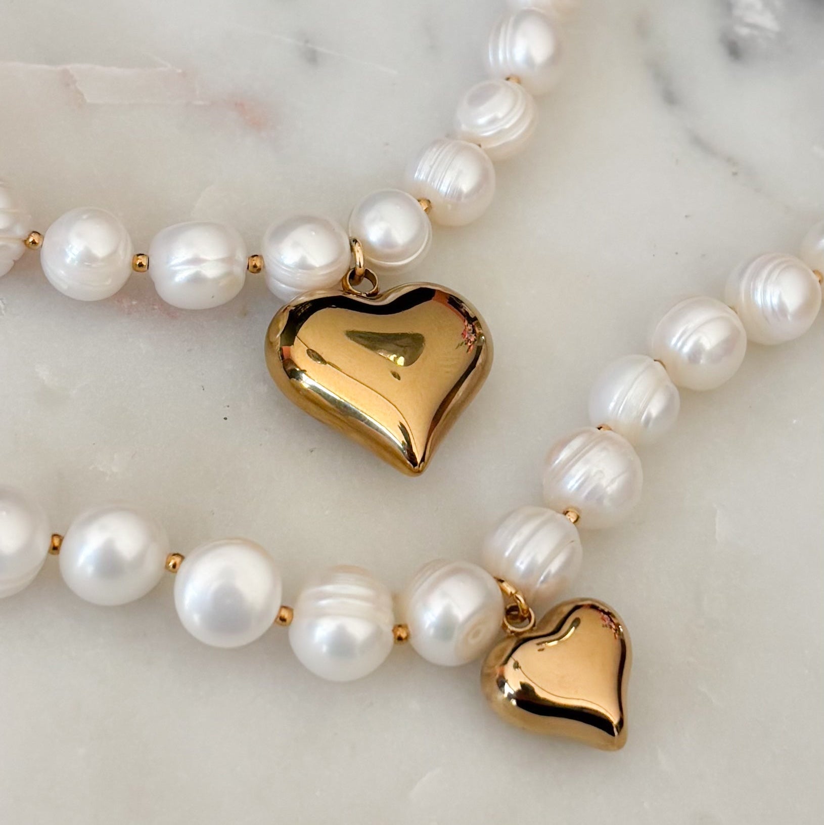 parel armband met grote arels en hartje hanger rvs goud