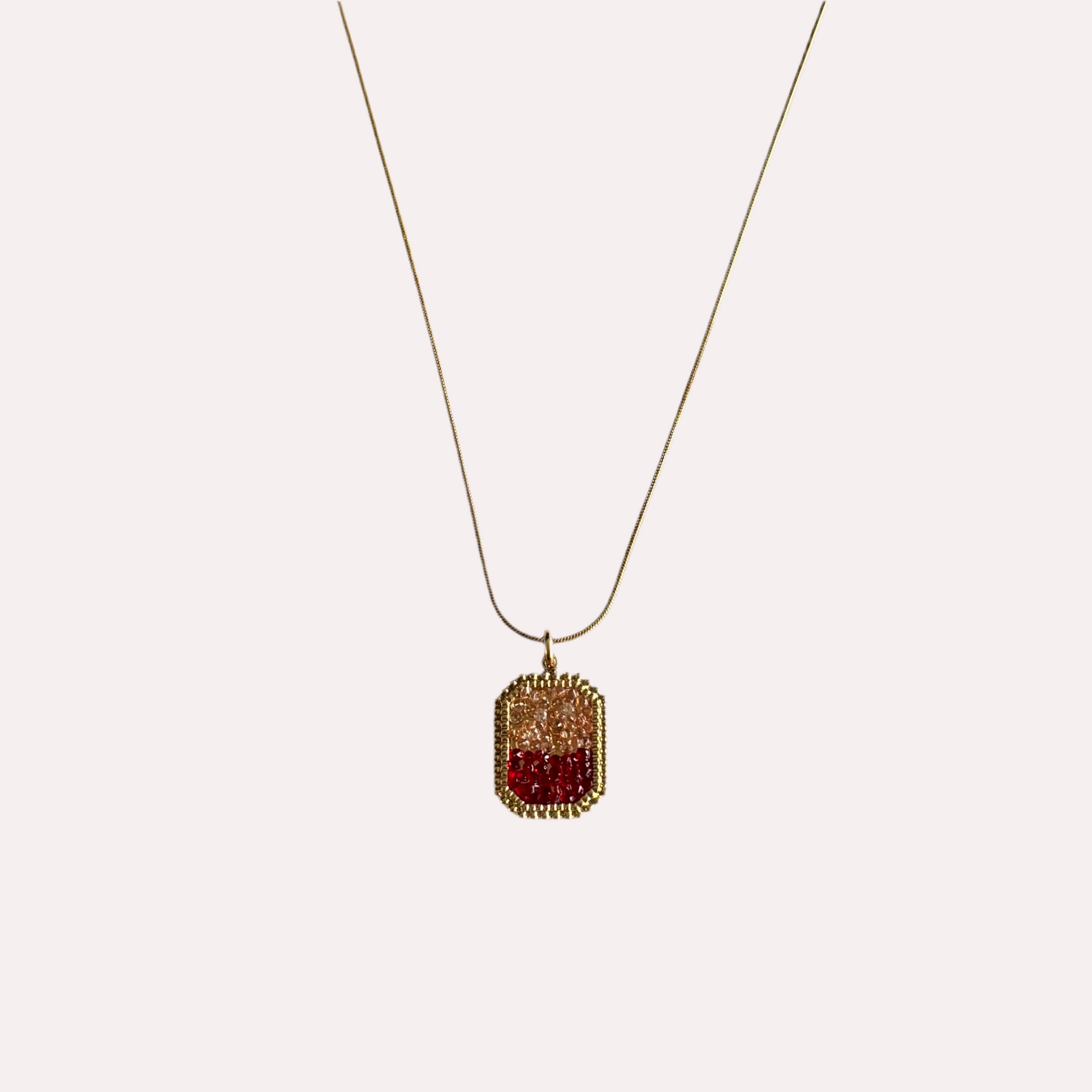 Gouden stainless steel ketting met rode hanger